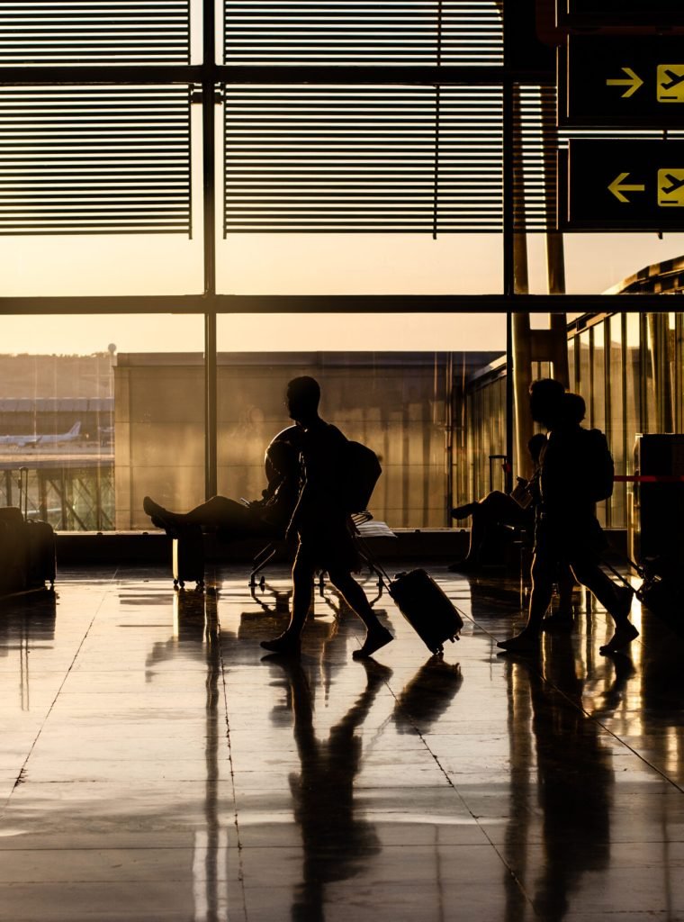 Silhouette of people walking inside a airport terminal